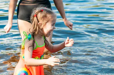 Little girl playing in the water at a beach 