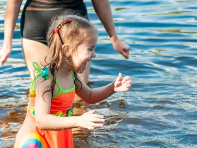 Little girl playing in the water at a beach 