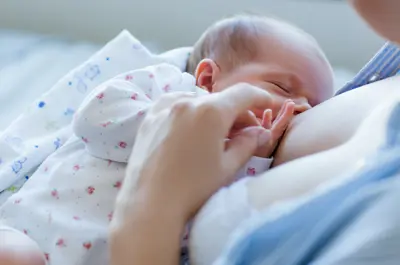 Mother breastfeeding newborn.