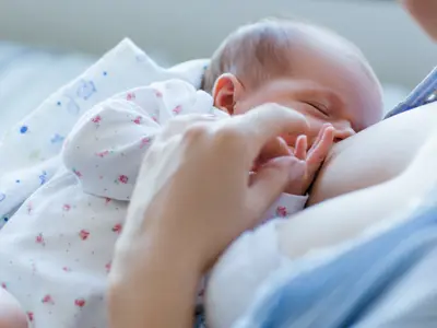 Mother breastfeeding newborn.