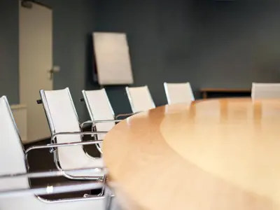 Empty boardroom with table and chairs