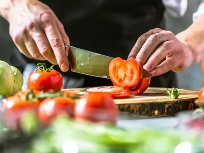 Chef cook preparing vegetables in kitchen 