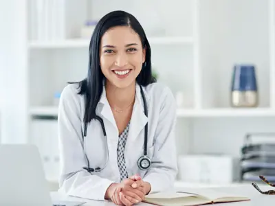 Portrait of a young doctor working at her desk