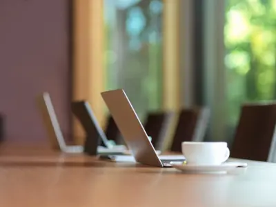 Laptops on desk with coffee mug