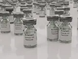Bivalent Covid19 Vaccine bottles sitting on white desk