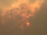 Sun behind clouds and haze from wild fires.